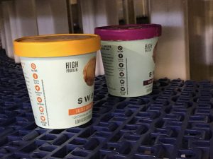 Ice Cream containers on an IJ White Spiral Freezer Blue Modular Plastic Belt